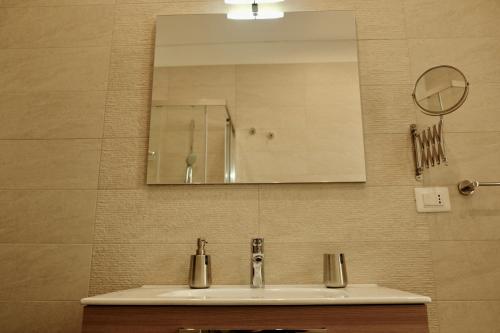 a bathroom with a sink and a mirror at B&B Don Savè in Marina di Schiavonea