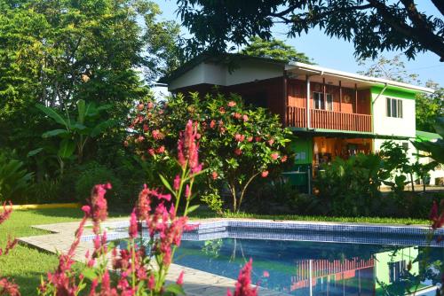 a house with a pool in front of it at Dolce Uvita in Uvita