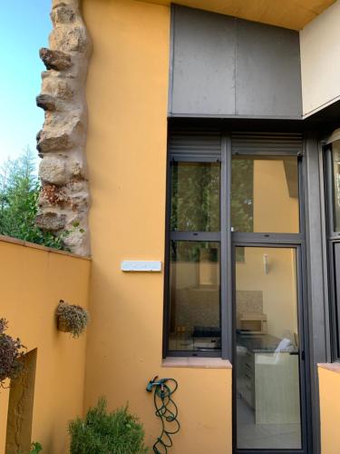 a glass door of a building with a window at L'Heura in Navata