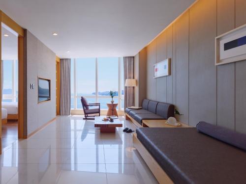 a living room with a couch and a chair at Sono Calm Yeosu in Yeosu