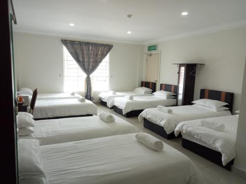 Кровать или кровати в номере Hotel Mutiara KGMMB, Melaka