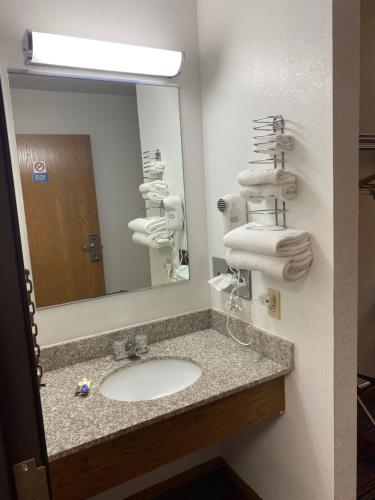 a bathroom with a sink and a mirror at Americas Best Value Inn Champaign in Champaign