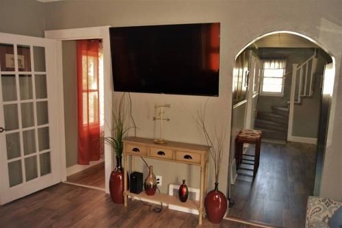 a living room with a flat screen tv on a wall at The Bungalow in Grand Forks
