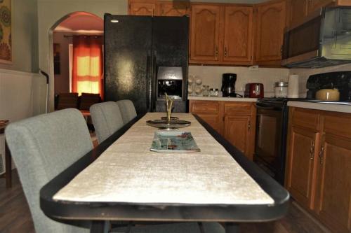 a kitchen with a table with a wine glass on it at The Bungalow in Grand Forks