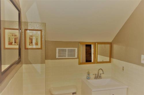 a white bathroom with a sink and a shower at The Bungalow in Grand Forks