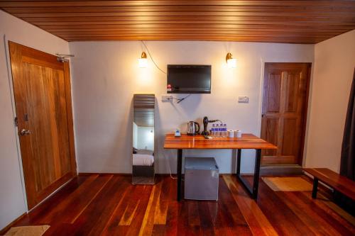 a room with a wooden table in a room at Joe Fisherman Inn in Pangkor
