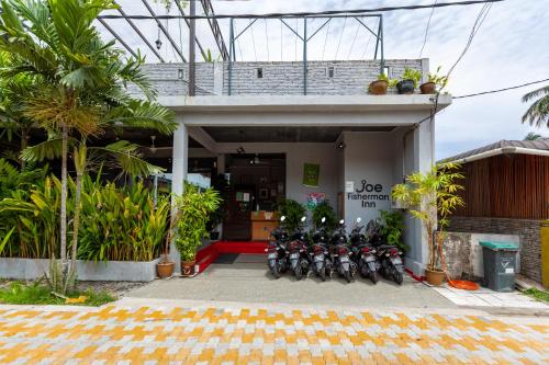 a row of motorcycles parked in front of a building at Joe Fisherman Inn in Pangkor