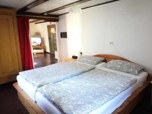 um quarto com uma cama grande e 2 almofadas em Häusle an der Hüle em Hohenstein