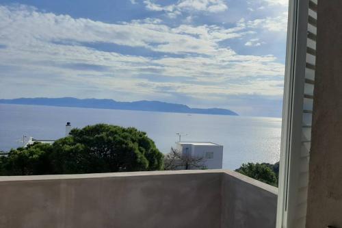 a view of the ocean from a window of a house at Athena s House in Platia Ammos