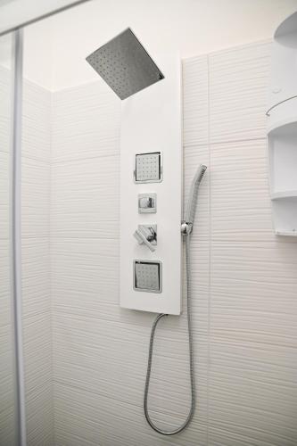 a shower with a hose attached to a wall at Don Giovanni in Alghero