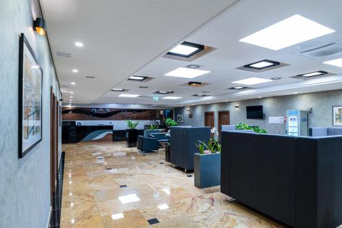 a lobby of a office with couches and tables at Hotel Wodnik in Bydgoszcz