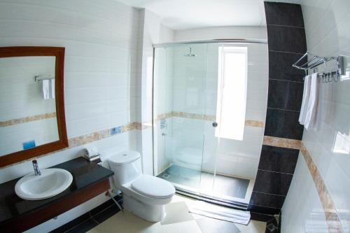 a bathroom with a shower and a toilet and a sink at Kampong Thom Palace Hotel in Kompong Thom