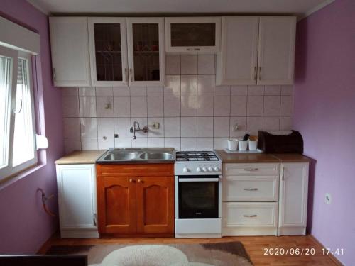 a small kitchen with a sink and a stove at Konak Mali Raj in Vrnjačka Banja