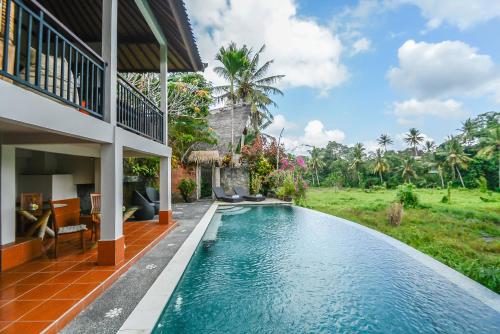 a house with a swimming pool next to a house at Le Sabot Ubud in Ubud