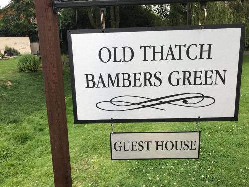a sign that reads old thicker farmers green and a guest house at Old Thatch Bambers Green in Takeley