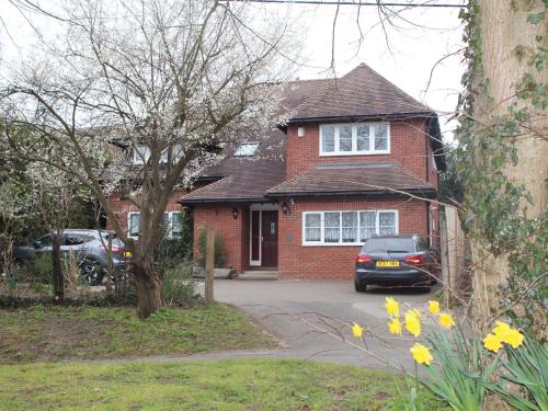 a red brick house with a car parked in the driveway at Oxfordbnb in Oxford