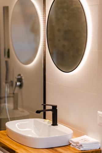a bathroom with a sink and a mirror at Rea Boutique Hotel in Himare