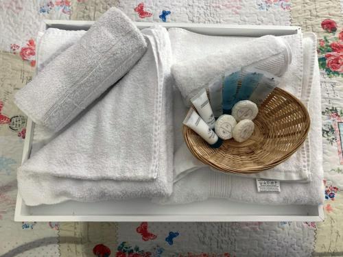 a basket of towels and towels on a table at Pew with a View - Seafront Cottages in Sandhaven