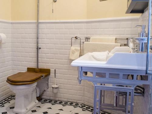 a bathroom with a blue sink and a toilet at The Post House in Kinsale