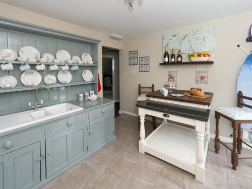 a kitchen with a sink and a piano in it at The Porterhouse in Willingham