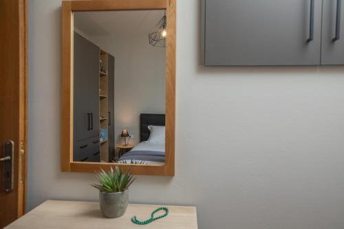 a mirror on a wall next to a bedroom at Citrus House in Razáta