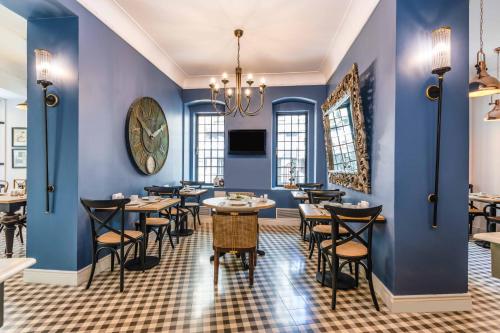 a restaurant with blue walls and tables and chairs at Petros Hotel in Istanbul