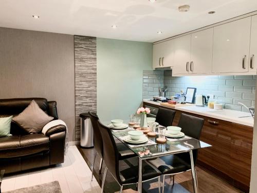 a kitchen and dining room with a table and a couch at Richmond House by Staytor Accommodation in Exeter