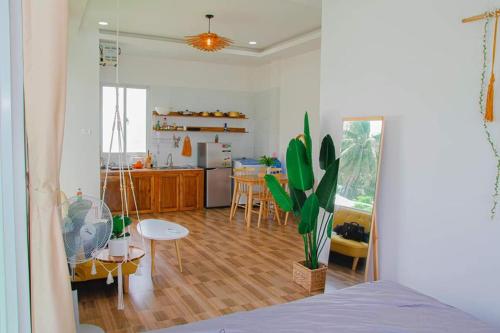 a room with a kitchen and a living room at sunset beach house 3 in Phu Quoc