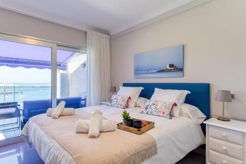 a bedroom with two beds with a view of the ocean at Amarre Bay in Puerto de Mogán