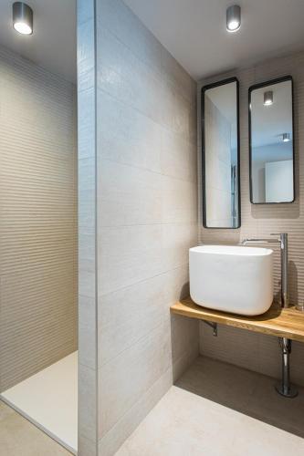 a bathroom with a sink and a mirror at Hôtel L'Ouvrée in Savigny-lès-Beaune