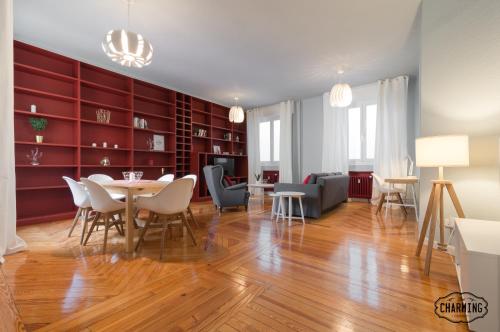 a living room with a dining room table and chairs at Charming Gran Vía Center in Madrid