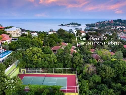 an aerial view of a tennis court in the trees at Samui Secret Villas in Choeng Mon Beach