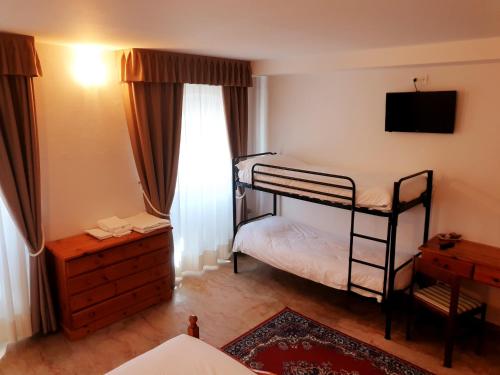 Säng eller sängar i ett rum på Albergo Trieste