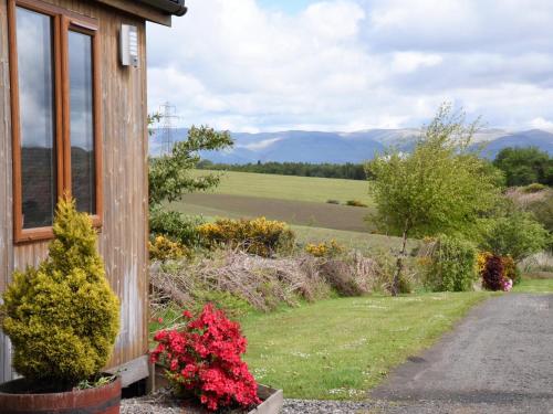 a house with a view of a field at Carr's Hill Luxury Safari Tents in Denny