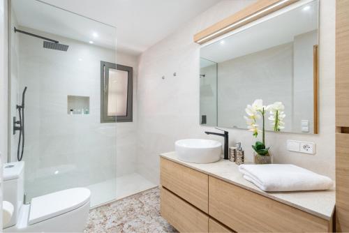 a bathroom with a sink and a mirror at Villa Isabel in Playa de Muro
