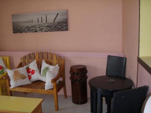 a living room with two chairs and a table at Anthurium Inn in Mactan