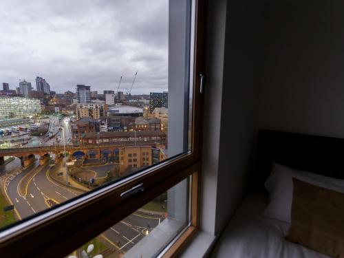 a window in a room with a view of a city at Live in Leeds Sky Penthouse in Leeds