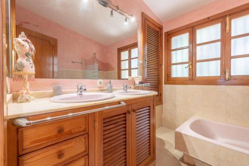 a bathroom with a sink and a tub and a tubermottermott at Villa Costa De Blanes in Calvià