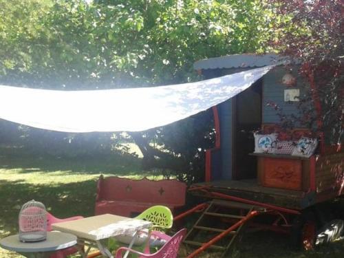 a group of chairs and a table and a tent at Le Moulin de Sonnailles in Cabriès