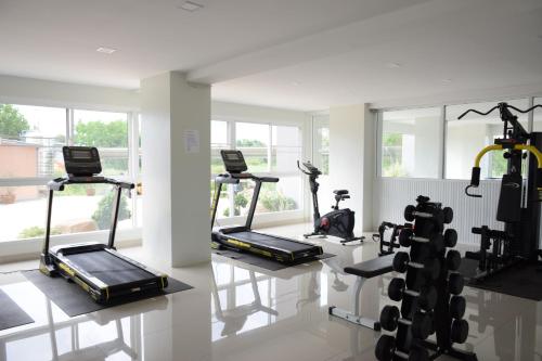 a gym with treadmills and elliptical machines at The grace kok udom in Prachin Buri