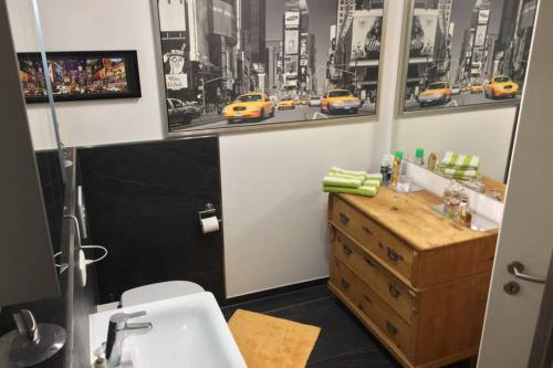 a bathroom with a sink and a yellow taxi at nice Apartment in Schwarzenbruck