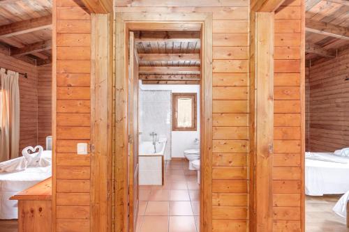 a wooden bathroom with a toilet and a sink at Finca L'hort Nou in Pollença