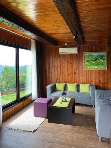 a living room with a couch and a table at Etno selo Moj Zavičaj in Gornji Milanovac