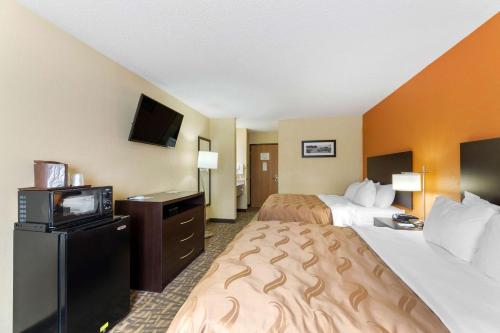 a hotel room with two beds and a television at Quality Inn Wooster in Wooster