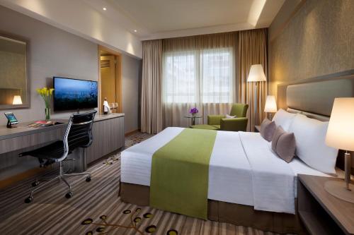 a hotel room with a large bed and a desk at Park Hotel Hong Kong in Hong Kong