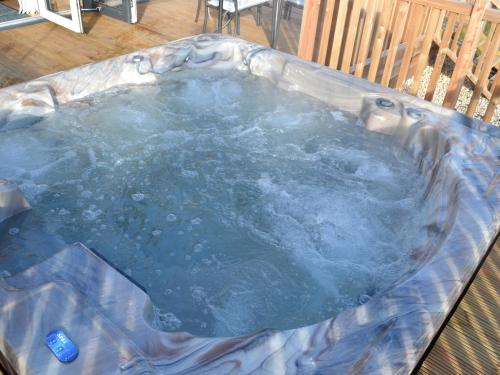 a hot tub in a chair with water in it at The Chiltern Lodges at Upper Farm Henton in Chinnor
