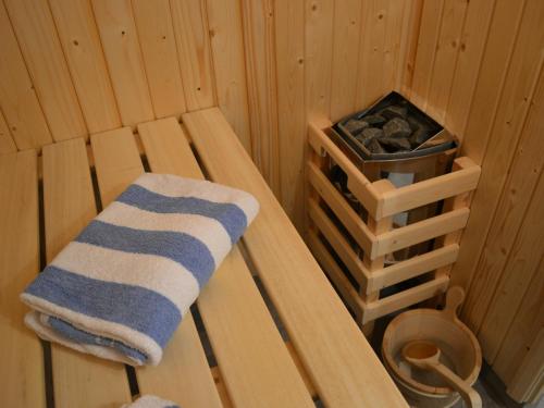 a towel sitting on a bench in a sauna at The Chiltern Lodges at Upper Farm Henton in Chinnor