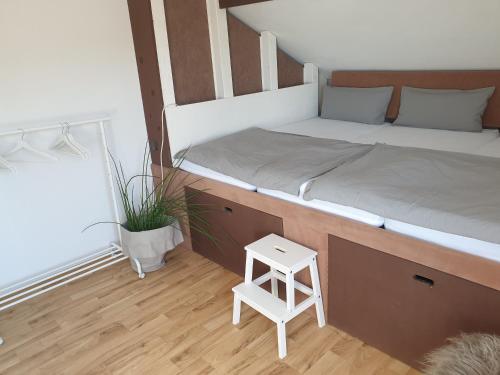 a bedroom with two beds and a small stool at Studio 11 in Neuffen