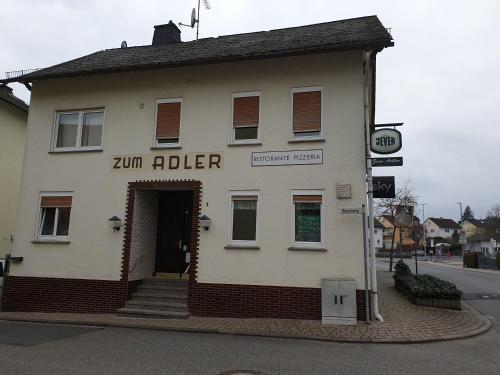 a building on the corner of a street at Pension Zum Adler in Limbach