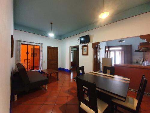 a living room with a table and a dining room at Hotel Suites Del Centro in Oaxaca City
